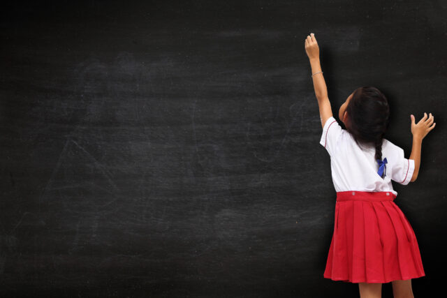 Girl drawing on blackboard